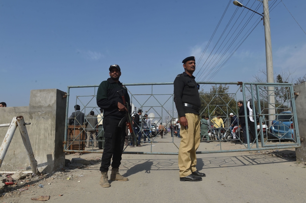 Pakistani policemen stand guard outside the checkpoint of Kot Lakhpat jail where Imran Ali, the suspect accused of raping and murdering six-year-old Zainab Fatima Ameen is detained, in Lahore on Saturday. — AFP