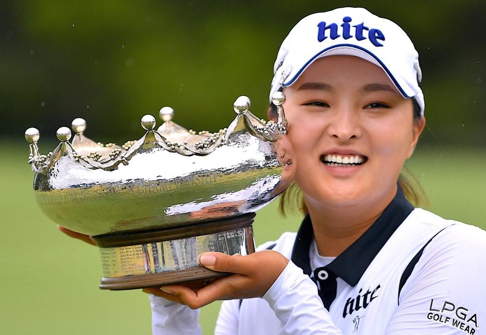 South Korea’s Ko Jin-young holds the trophy after winning the Australian Open Golf Tournament at the Kooyonga golf course in Adelaide Sunday. — Reuters