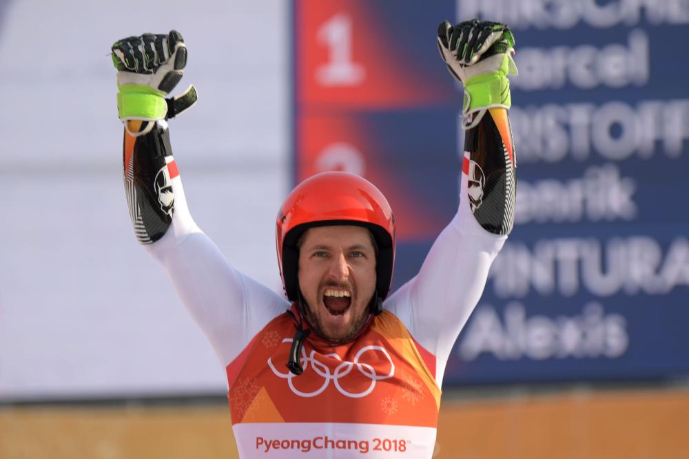 Austria’s Marcel Hirscher celebrates on the podium during the victory ceremony after the men’s giant slalom at the Pyeongchang 2018 Winter Olympic Games Sunday. — AFP