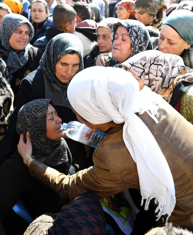 Syrian Kurds mourn in the northern town of Afrin during the funeral of fighters from the People's Protection Units (YPG) militia and the Women's Protection Units (YPJ), killed in clashes in the Kurdish enclave in northern Syria on the border with Turkey. — AFP