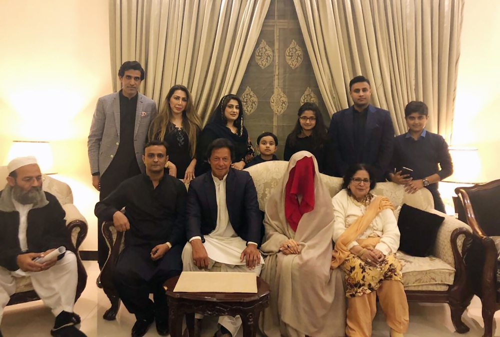 This handout picture released by Pakistan Tehreek-i-Insaaf (PTI) on Monday, shows Pakistani cricketer-turned-opposition leader and head of the Pakistan Tehreek-i-Insaaf (PTI) party Imran Khan, center, posing for a photograph with his new wife Bushra Wattoo, second right, along with relatives during a wedding ceremony in Lahore. - AFP