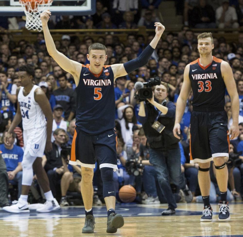 In this file photo, Virginia's Kyle Guy (5) and Jack Salt (33) walk off the court following a victory in an NCAA college basketball game against Duke, in Durham, N.C. The Cavaliers remained at No. 1 in Monday's latest AP Top 25 poll, earning 42 of 65 first-place votes. — AP