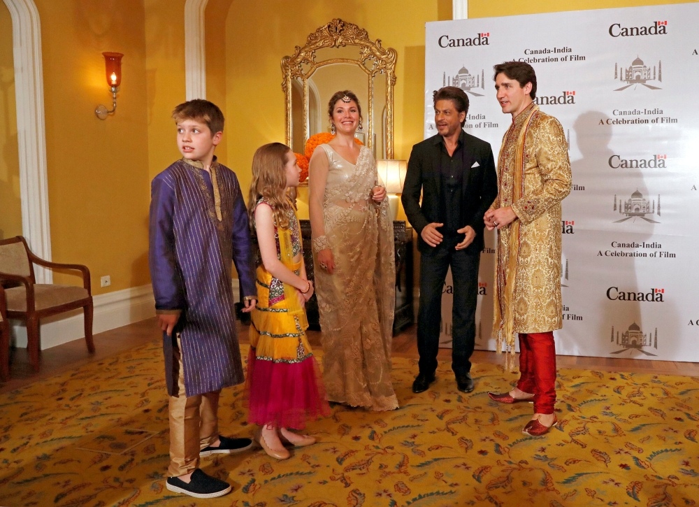 Canadian Prime Minister Justin Trudeau, his wife Sophie Gregoire Trudeau, their daughter Ella Grace and son Xavier pose with Bollywood actor Shah Rukh Khan in Mumbai, India, on Tuesday. — Reuters