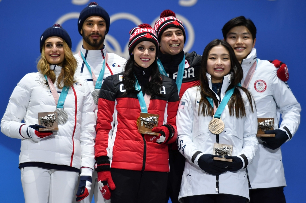 (L-R) France's silver medalists Gabriella Papadakis and Guillaume Cizeron, Canada's gold medalists Tessa Virtue and Scott Moir, and USA's bronze medalists Maia Shibutani and Alex Shibutani pose on the podium during the medal ceremony for the figure skating ice dance at the Pyeongchang Medals Plaza during the Pyeongchang 2018 Winter Olympic Games in Pyeongchang on Tuesday. — AFP