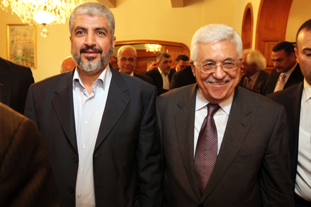 Palestinian Authority President and leader of Fatah Mahmoud Abbas (right) meets with Hamas leader Khaled Mashaal (left) in Cairo, in 2011 as the two announced a partnership between their parties. — Courtesy photo 