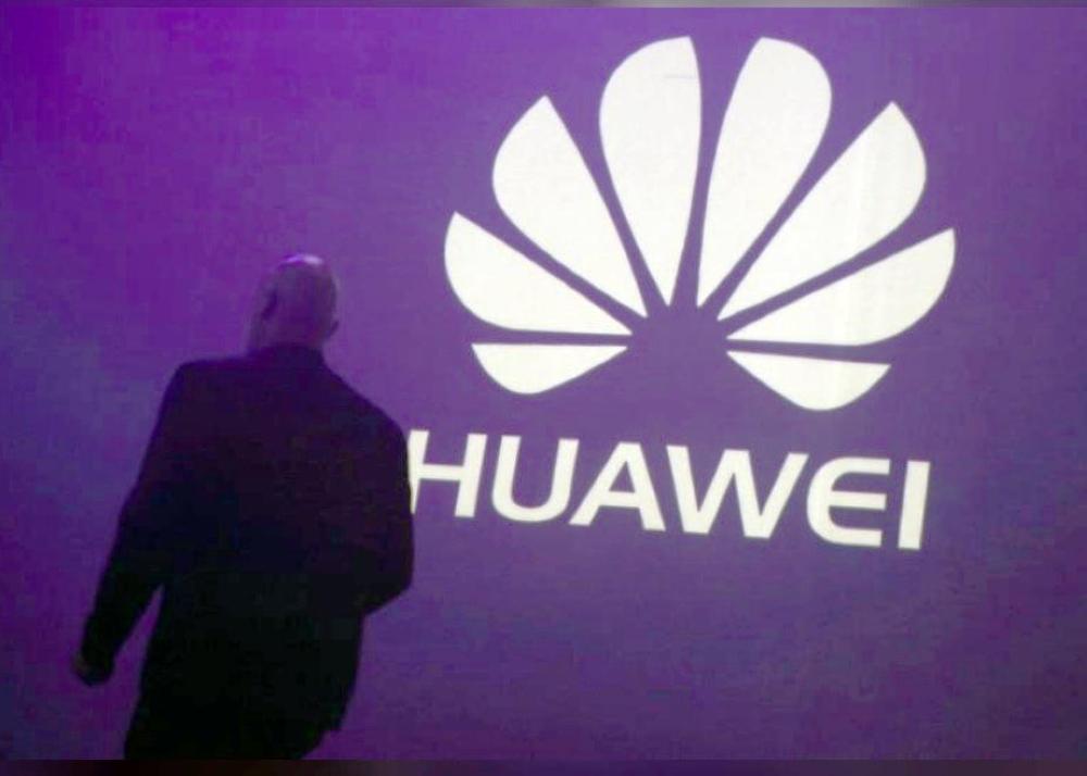 A man walks past a logo during the presentation the Huawei's new smartphone, the Ascend P7, launched by China's Huawei Technologies in Paris, in this file photo. — Reuters