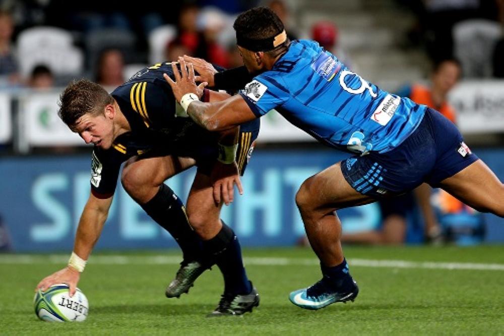 Teihorangi Walden of the Highlanders scores a try in the tackle of Augustine Pulu of the Blues during their Super Rugby match at Forsyth Barr Stadium in Dunedin, New Zealand, Friday. — AFP
