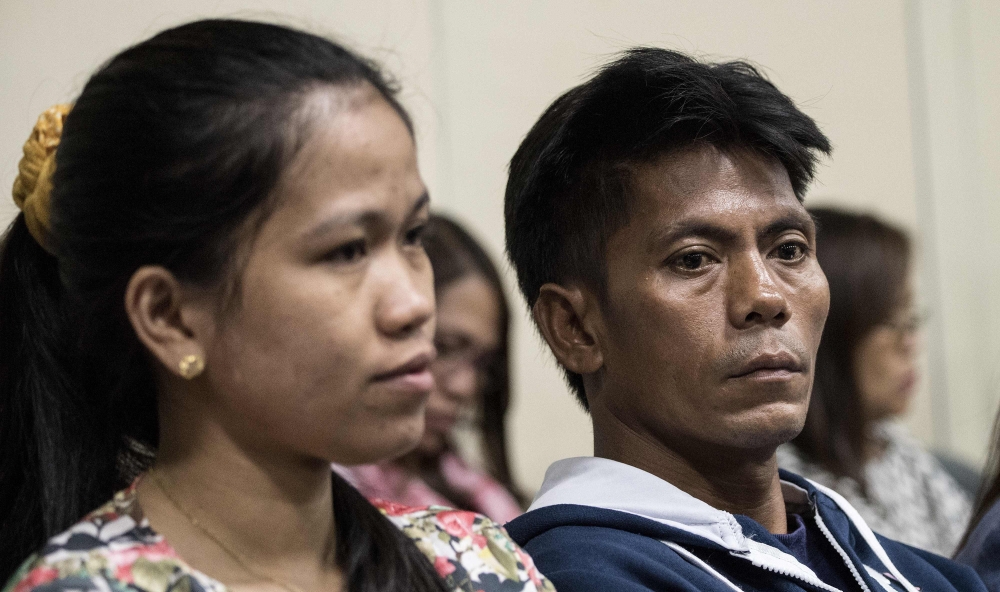 Relatives of Philippine overseas worker Joanna Demafelis, whose body was found inside a freezer in Kuwait, attend a senate hearing on migrant workers at the Senate building in Manila on Wednesday. — AFP file photo