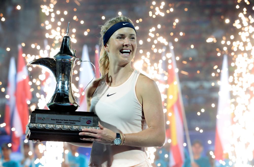 Elina Svitolina of Ukraine holds up the trophy after defeating Daria Kasatkina of Russia at the Dubai Duty Free Tennis Championship Saturday. — Reuters