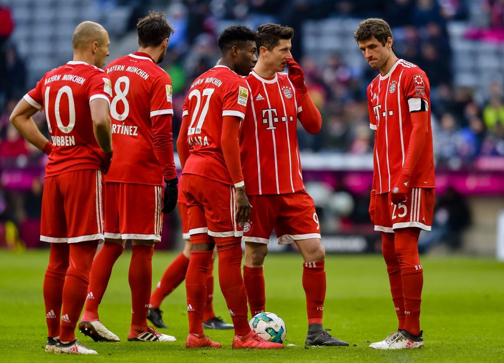 Bayern Munich's players discuss during the German first division Bundesliga football match against Hertha Berlin in Munich Saturday. — AFP