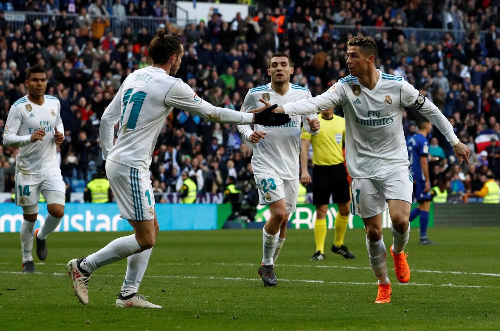 Real Madrid’s Cristiano Ronaldo (R) celebrates scoring their first goal with Gareth Bale against Deportivo Alaves at Santiago Bernabeu, Madrid, Saturday. — Reuters