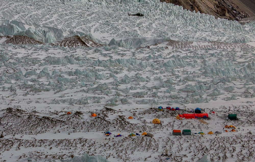 A Pakistani army helicopter flies over K2 base camp on Sunday. — AFP