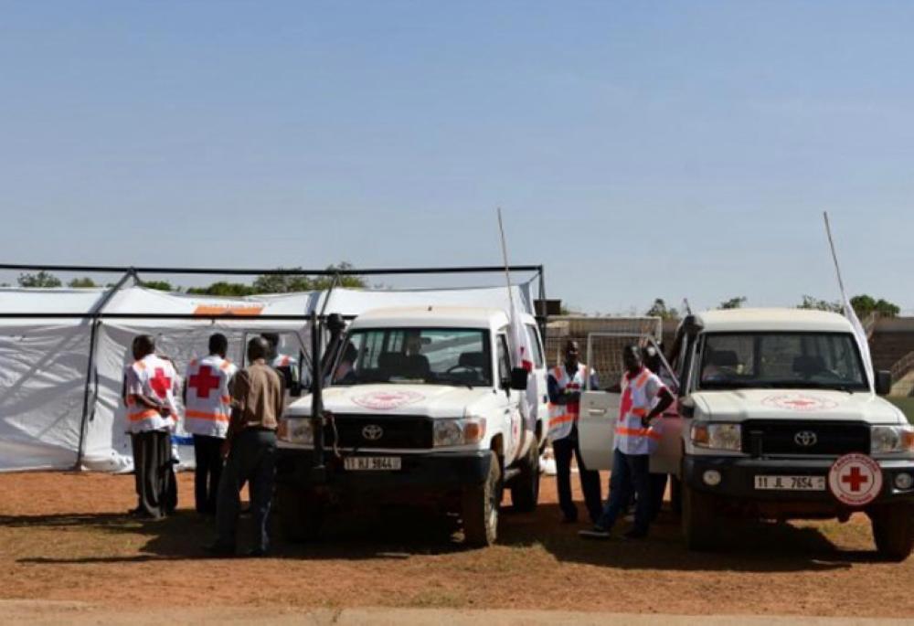 Red Cross members stand at the municipal stadium where an emergency medical post was established, after a coordinated assault on the army headquarters and French embassy in the capital Ougadougou, Burkina Faso on Friday. — Reuters
