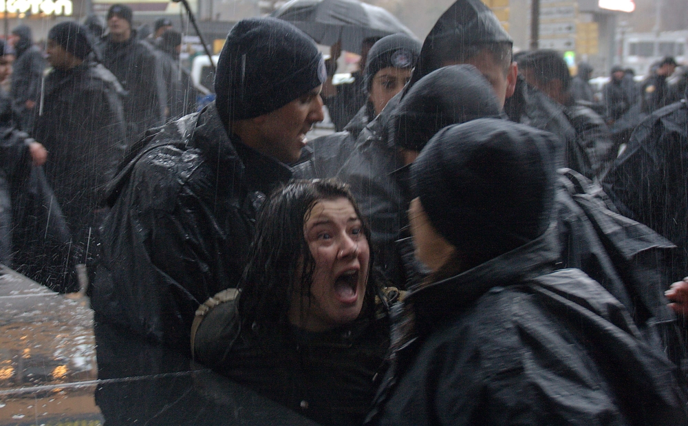 Turkish woman shouts at Turkish riot police as they try to detain her during a rally for Women's rights in Ankara. — AFP