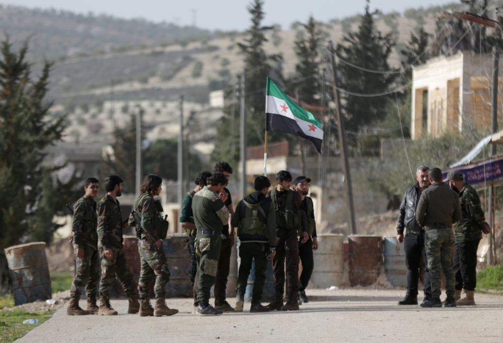 Turkish-backed Free Syrian Army fighters gather at mount Bafliyun, in the Afrin region, Syria. — Reuters