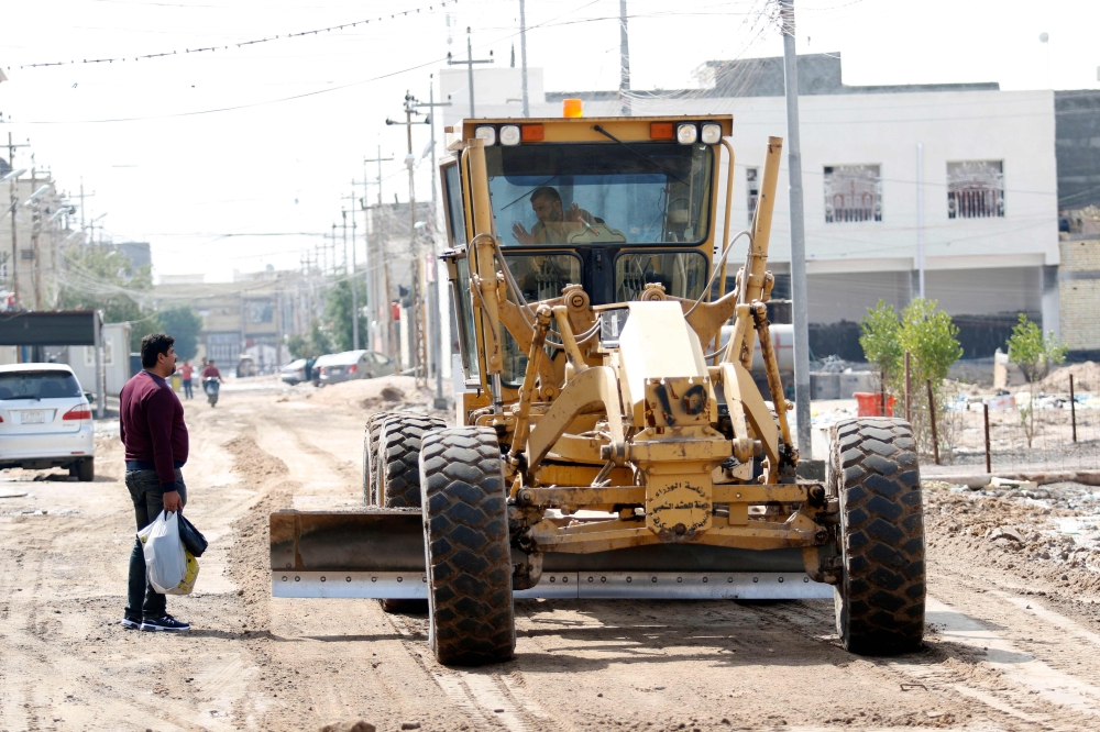 A member of the Hashed Al-Shaabi (Popular Mobilization Forces) operates a tractor in the southern city of Basra. Tens of thousands of Iraqis mobilized in 2014 and formed the Hashed Al-Shaabi, a paramilitary umbrella organization set up to fight Daesh (the so-called IS) group, in response to a call by the country's top Shiite authority, Ali Sistani. — AFP