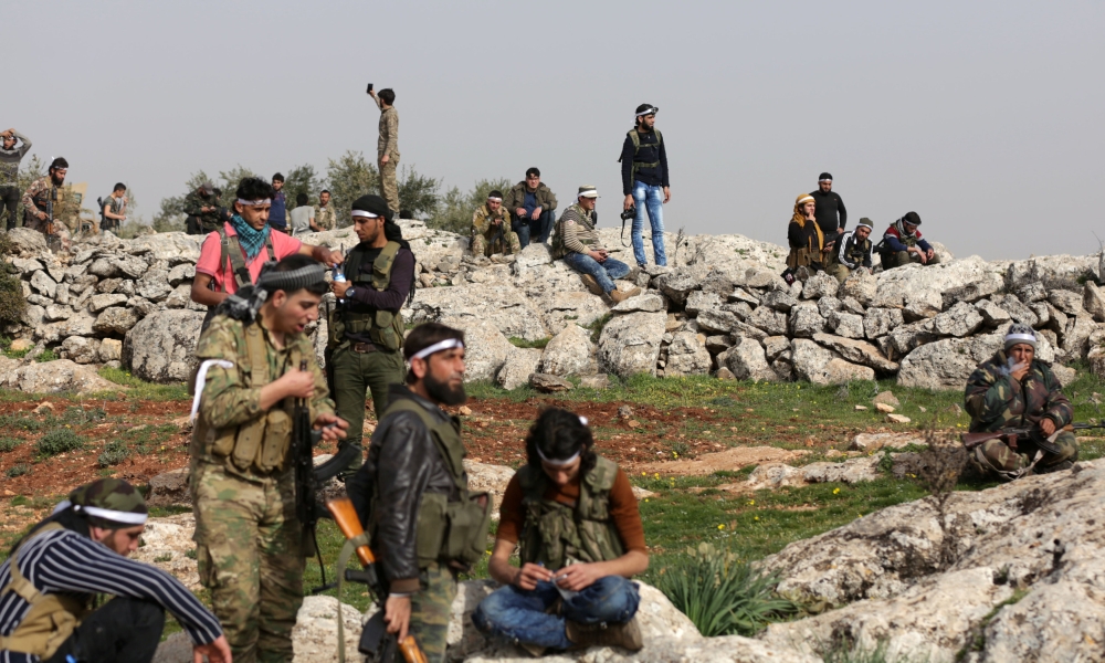 Turkish-backed Free Syrian Army fighters gather as they advance north of Afrin, Syria. — Reuters