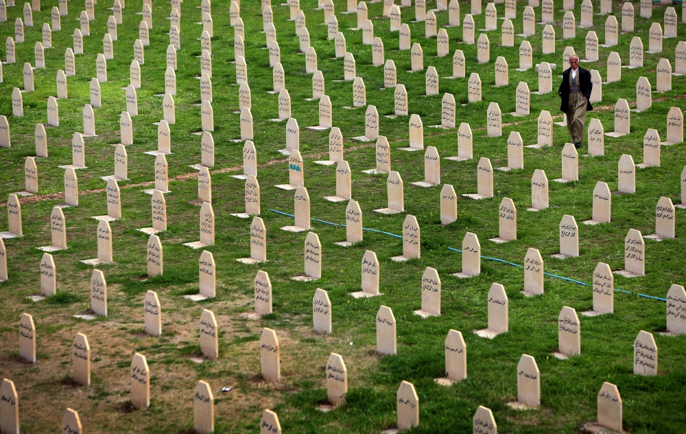 In this file photo taken on March 16, 2014, an Iraqi Kurd man walks past grave stones as he visits a graveyard for the victims of a gas attack by former Iraqi president Saddam Hussein in 1988 in the Kurdish town of Halabja, 300 km (190 miles) northeast of Baghdad. — AFP