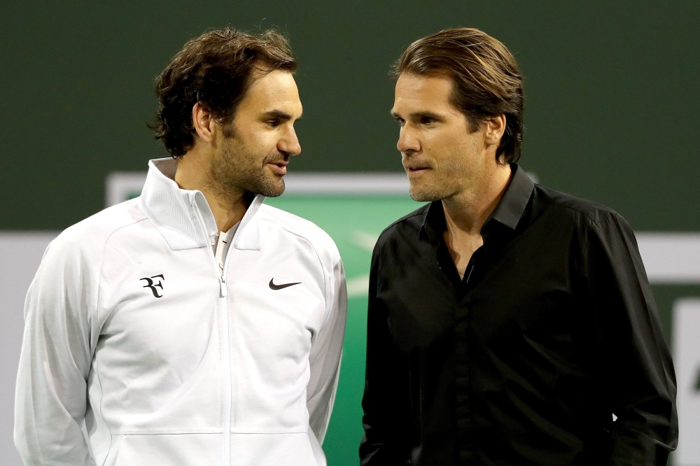 Roger Federer and Tommy Haas wait for a video tribute to begin before Haas officially announces his retirement at a ceremony after the Roger Federer quarterfnal match against Hyeon Chung during of the BNP Paribas Open at the Indian Wells Tennis Garden on Thursday in Indian Wells, California. — AFP