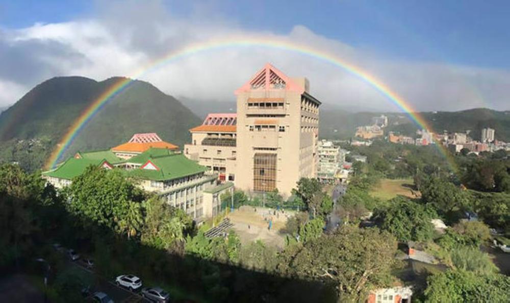 A rainbow is seen over Taipei's Yangmingshan mountain range which is known for its long-lasting rainbows.