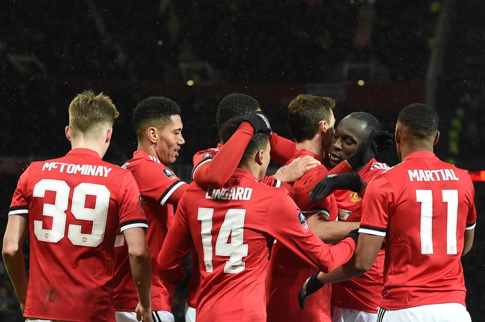 Manchester United’s Nemanja Matic celebrates scoring with teammates during their English FA Cup quarterfinal match against Brighton and Hove Albion at Old Trafford in Manchester Saturday. — AFP