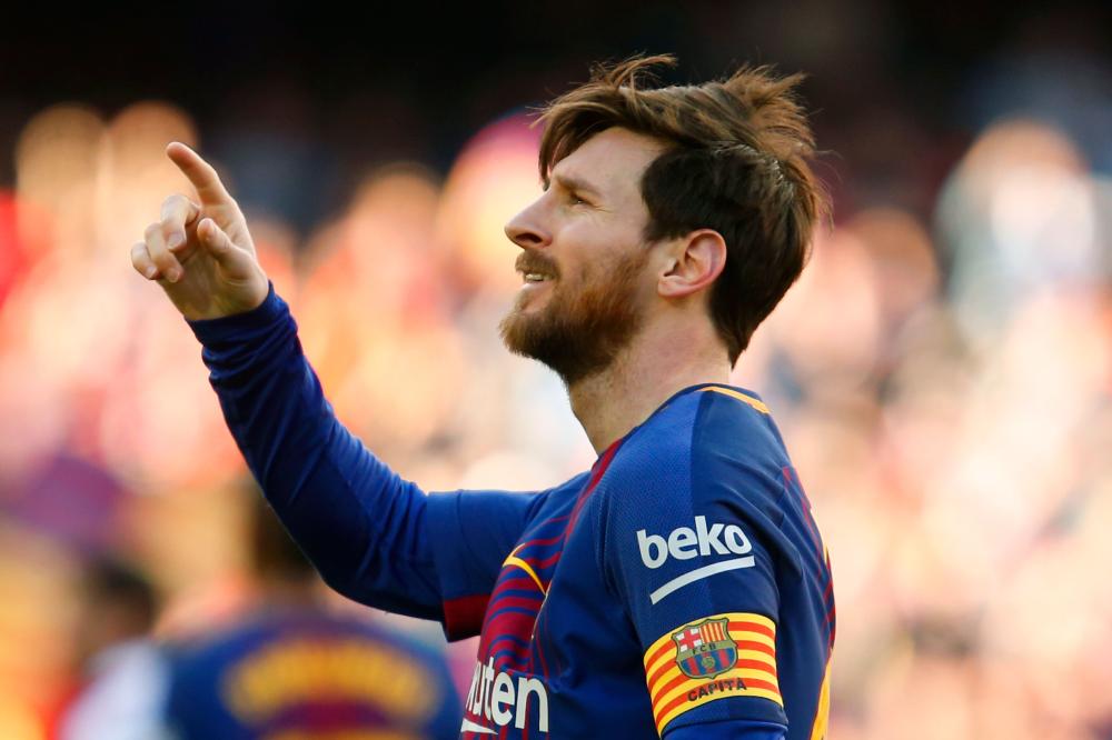 Barcelona's Lionel Messi celebrates after scoring during the Spanish League football match against Athletic Club Bilbao at the Camp Nou Stadium in Barcelona Sunday. — AFP