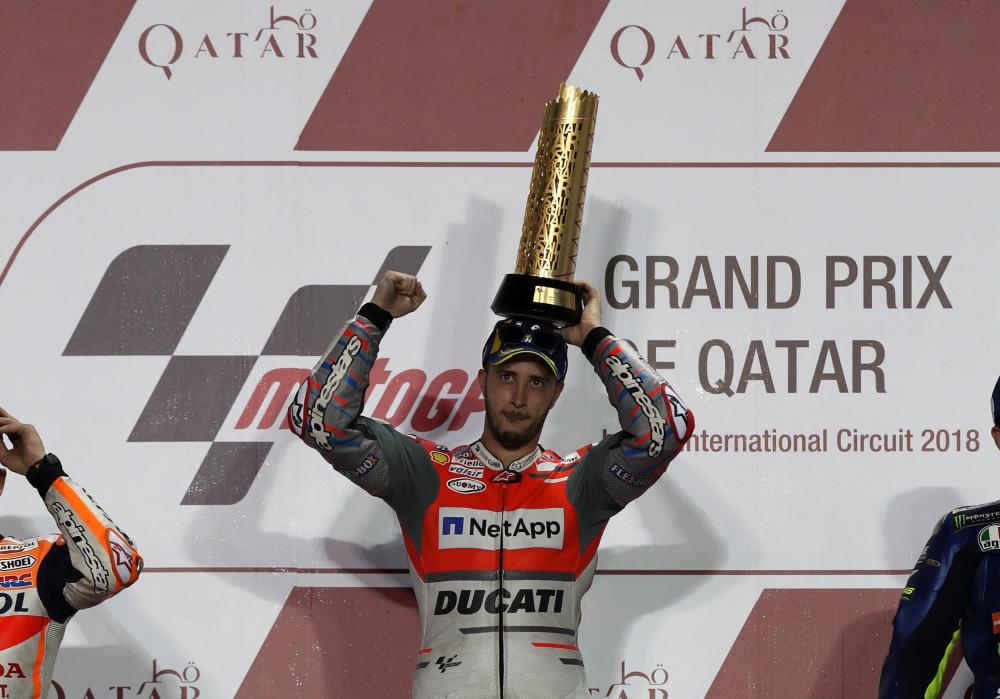 First-placed Ducati Team rider Andrea Dovizioso of Italy holds up the trophy. — Reuters