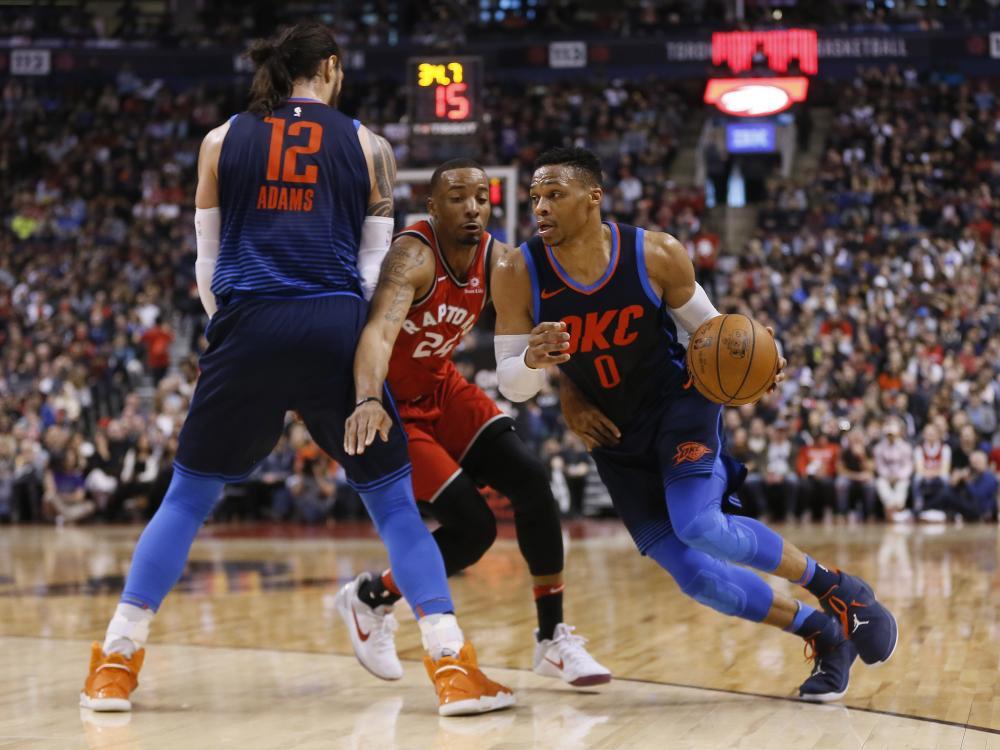 Oklahoma City Thunder’s guard Russell Westbrook drives to the basket past Toronto Raptors’ guard Norman Powell as teammate Steven Adams puts up a screen during their NBA game at the Air Canada Centre in Toronto Sunday. — Reuters