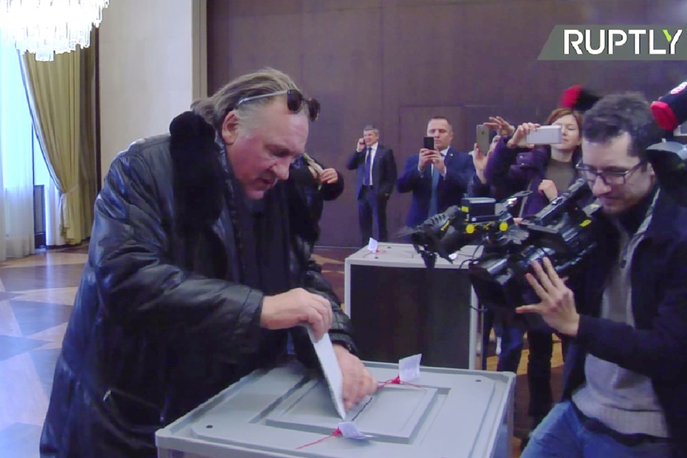 A video grab made from footage shot by Ruptly video news agency on Monday, shows French-Russian actor Gerard Depardieu casting his ballot as he votes during Russia's presidential election at the Russian Embassy in Paris. - AFP
