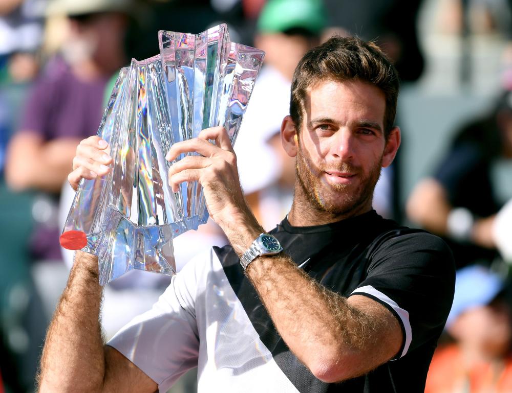 Juan Martin Del Potro of Argentina poses with the trophy after beating Roger Federer of Switzerland at the BNP Paribas Open in Indian Wells Sunday. — AFP 