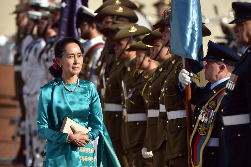 Myanmar’s State Counselor Aung San Suu Kyi, left, receives an official welcome on the forecourt during her visit to Parliament House in Canberra on Monday. — AFP