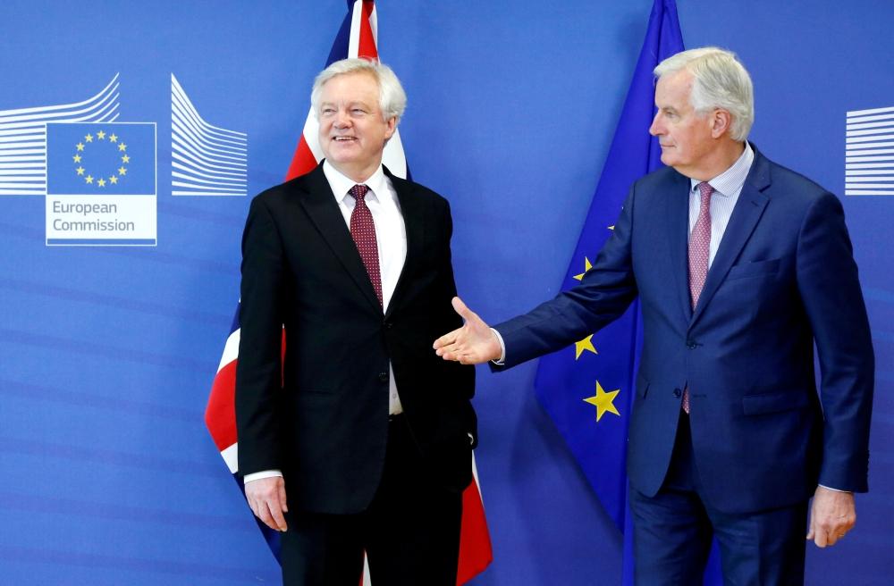 Britain’s Secretary of State for Exiting the European Union David Davis and European Union’s chief Brexit negotiator Michel Barnier pose ahead of a meeting in Brussels, Belgium, on Monday. — Reuters