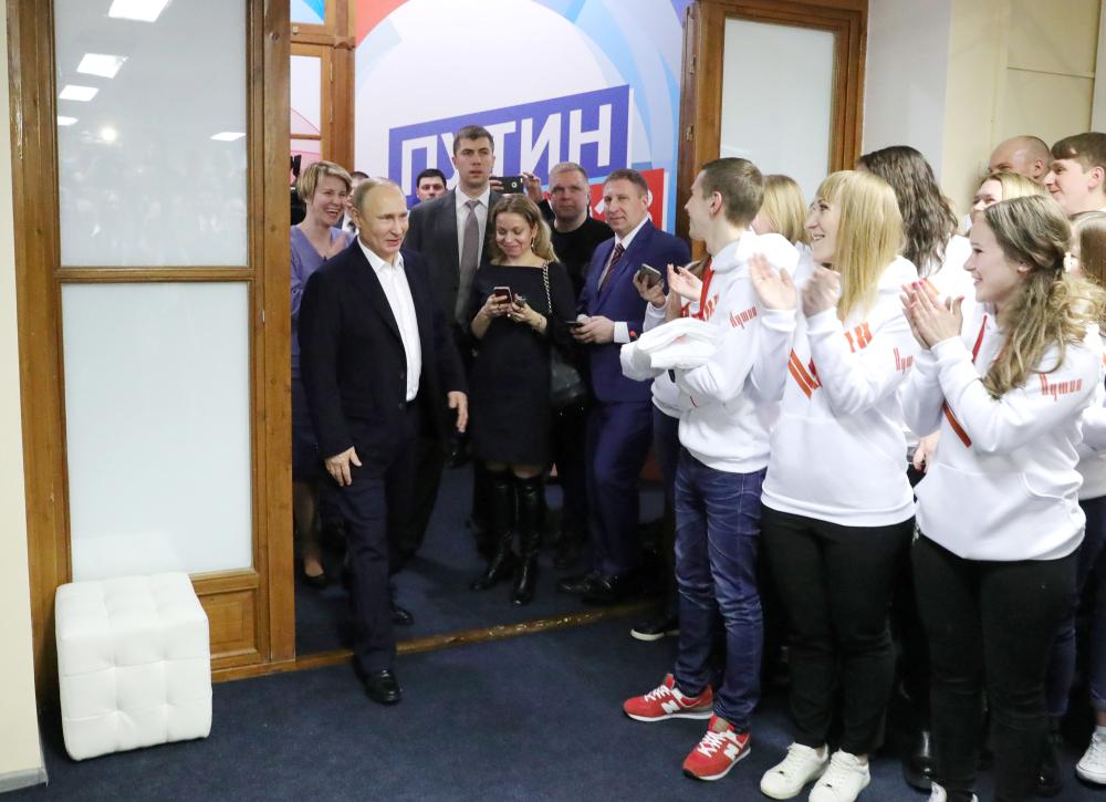 Russian President Vladimir Putin visits his campaign headquarters in Moscow on Sunday. — AFP