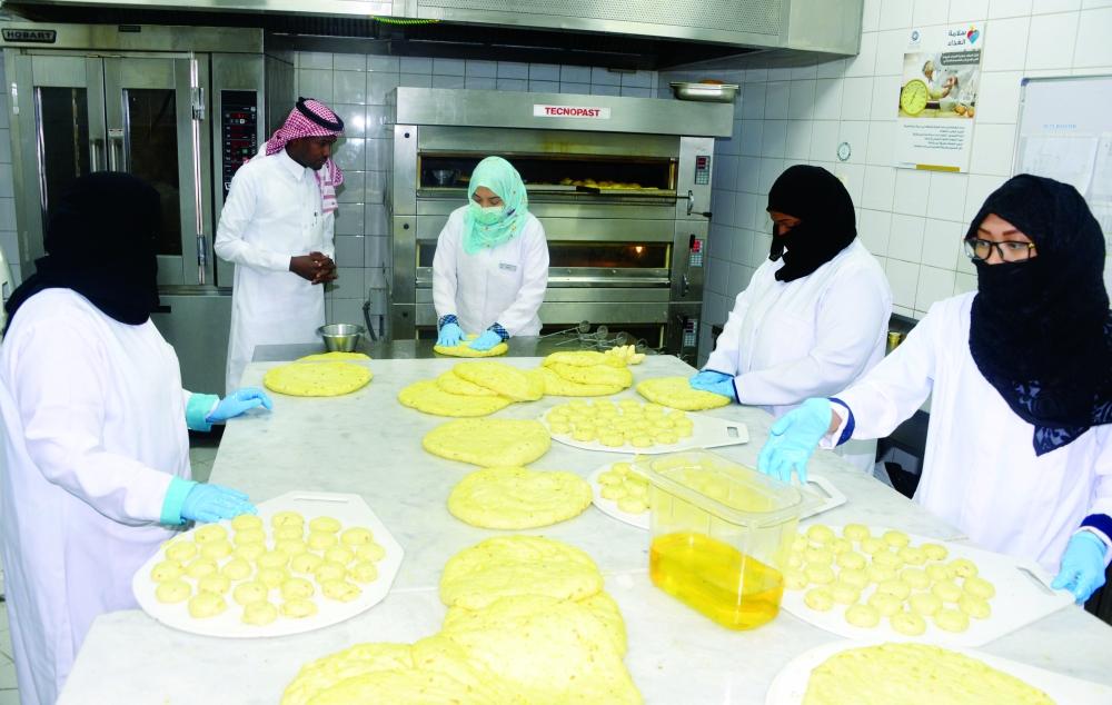 Saudi women work as chefs at a hotel in Makkah.
