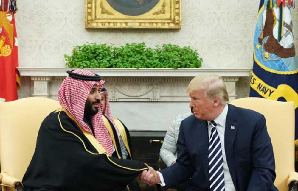 US President Donald Trump (R) shakes hands with Saudi Arabia's Crown Prince Muhammad Bin Salman in the Oval Office of the White House on March 20, 2018 in Washington, DC. — AFP