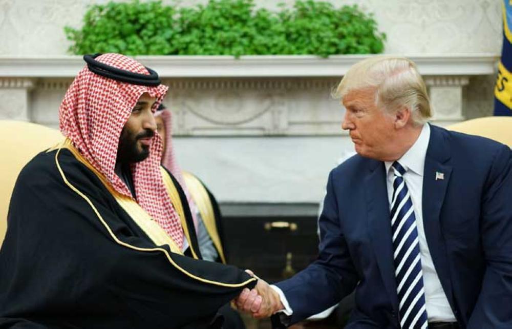 US President Donald Trump (R) shakes hands with Saudi Arabia's Crown Prince Muhammad Bin Salman in the Oval Office of the White House on March 20, 2018 in Washington, DC. — AFP