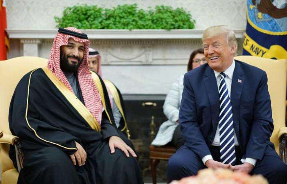US President Donald Trump (R) shakes hands with Saudi Arabia's Crown Prince Muhammad Bin Salman in the Oval Office of the White House on March 20, 2018 in Washington, DC. — AFP