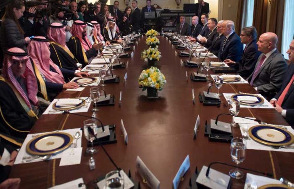 US President Donald Trump (R) shakes hands with Saudi Arabia's Crown Prince Muhammad Bin Salman in the Oval Office of the White House on March 20, 2018 in Washington, DC. — AFP