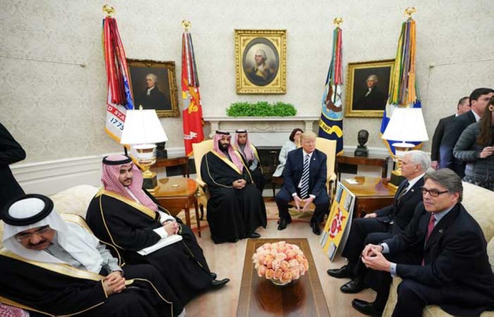 US President Donald Trump (R) shakes hands with Saudi Arabia's Crown Prince Muhammad Bin Salman in the Oval Office of the White House on March 20, 2018 in Washington, DC. — AFP