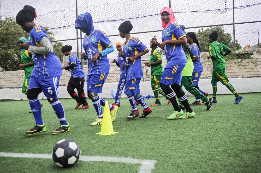 Somali football players of Golden Girls Football Center, Somalia's first female soccer club, take part in a training session at Toyo stadium in Mogadishu. The sight of young women playing football is highly unusual in Somalia, due to societal pressures as well as fear of Al-Shabaab. - AFP