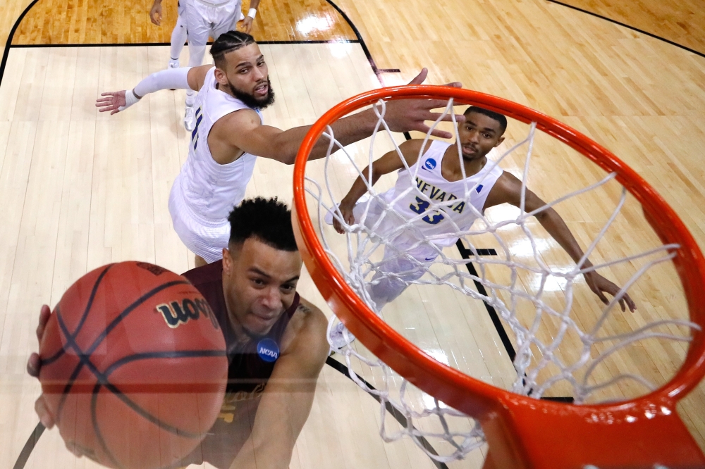 Marques Townes No. 5 of the Loyola Ramblers drives to the basket against Cody Martin No. 11 of the Nevada Wolf Pack in the second half during the 2018 NCAA Men's Basketball Tournament South Regional at Philips Arena on Thursday in Atlanta, Georgia.   — AFP