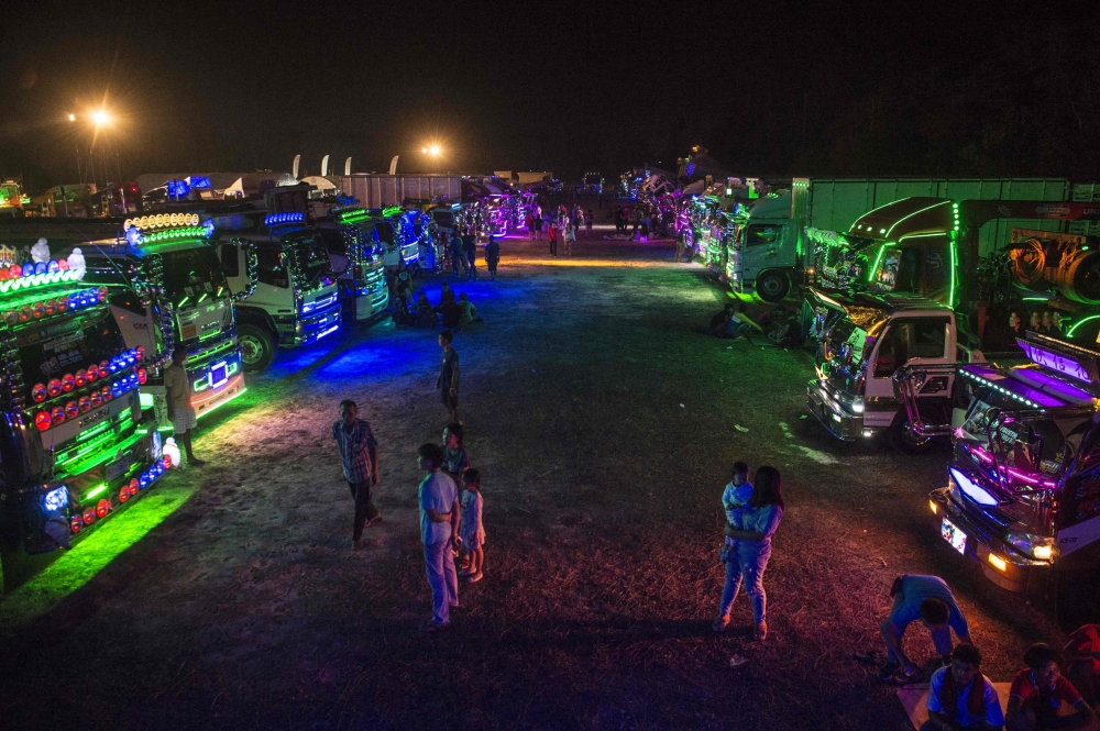 Rows of custom-decorated trucks are parked in a field at a fancy truck party in the Thai coastal province of Rayong in this Dec. 23, 2017 file photo. — AFP