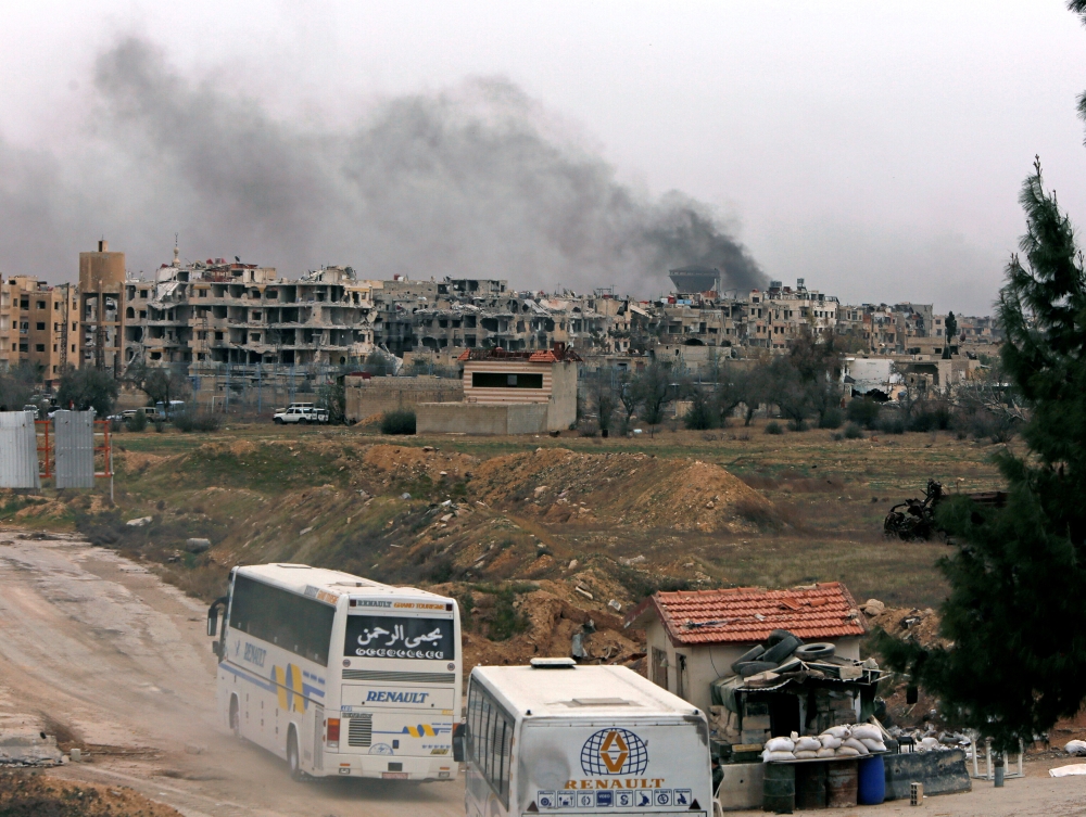 Buses are seen entering into rebels Harasta area in eastern Ghouta in Damascus, Syria, on Friday. — Reuters