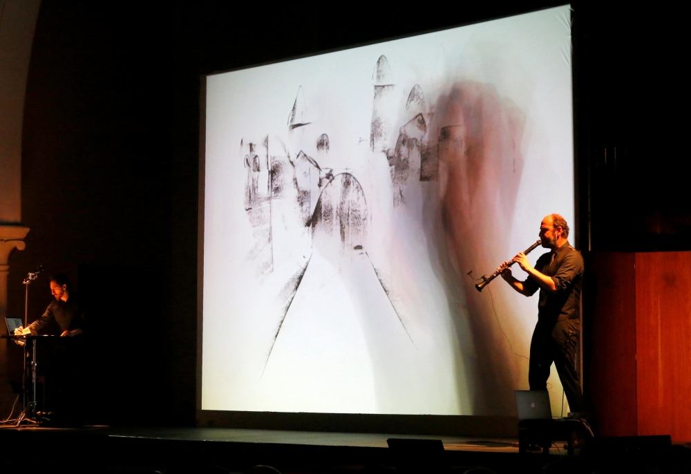 Kinan Azmeh plays the clarinet as Kevork does live sketching during their performance in Beirut, Lebanon. — Reuters