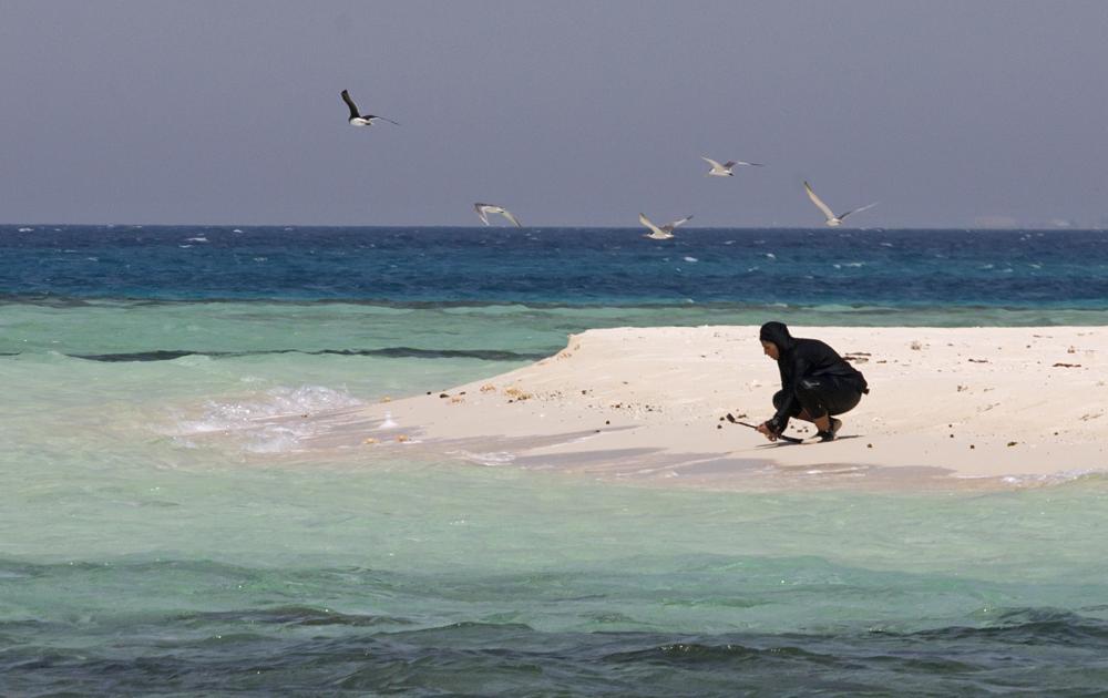 In this March 7 photo, Nouf Alosaimi, a 29-year-old Saudi diving instructor, prepares to explore the waters off a sandy island in the Red Sea near King Abdullah Economic City.