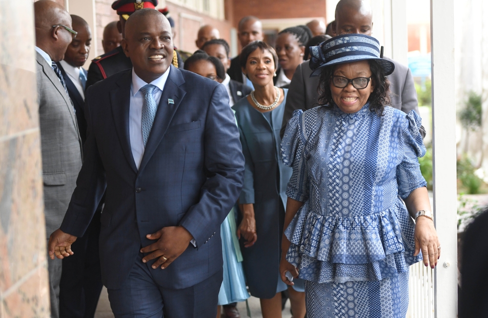 Botswana's new President Mokgweetsi Masisi (L), flanked by the Speaker of the National Assembly Gladys K. T Kokorwe, leaves after taking the oath as the 5th President at the National Assembly in Gaborone on Sunday. — AFP