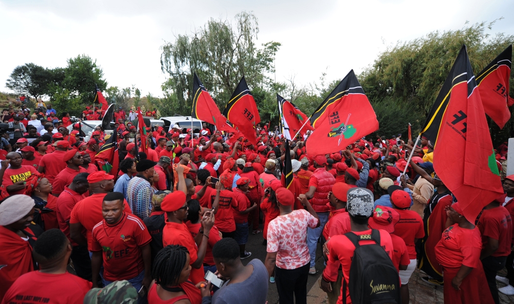 Mourners and members of the opposition party Economic Freedom Fighters (EFF) react outside Winnie Madikizela-Mandela’s home in Soweto, Johannesburg, on Tuesday. — EPA