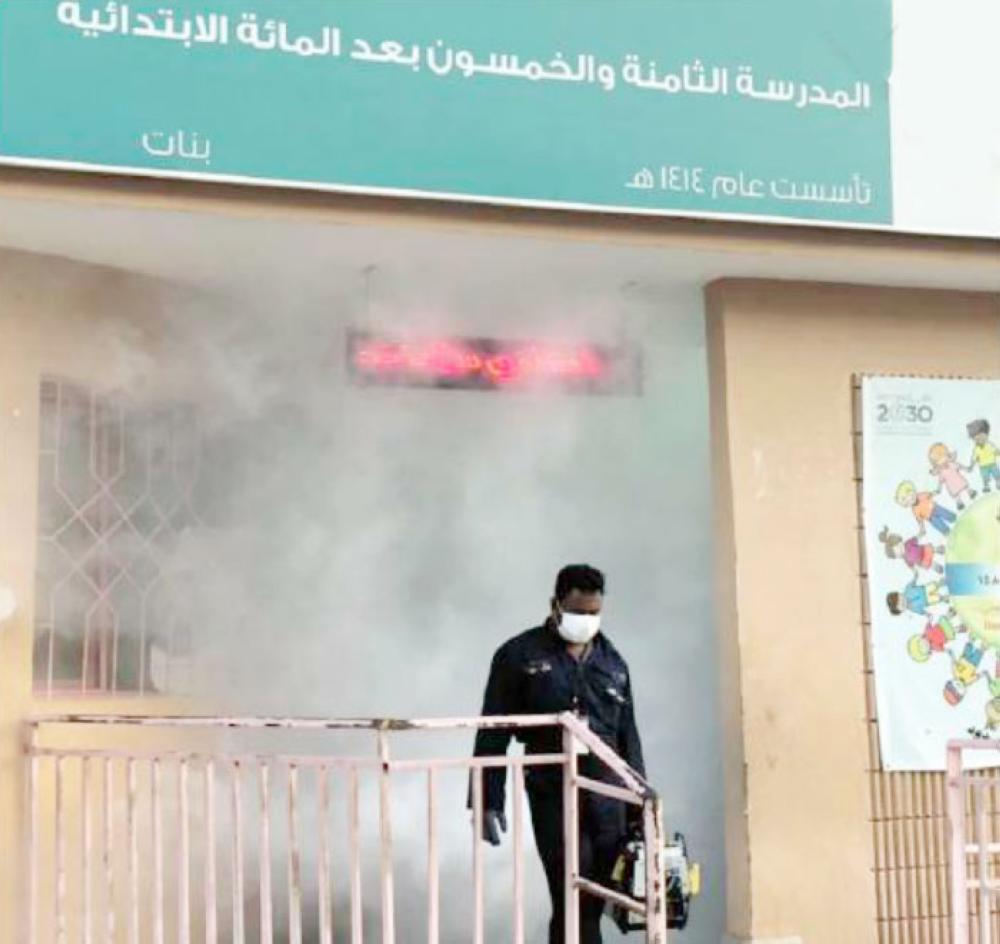 A worker comes out of a school building in Jeddah after sanitizing the premises. officials said as many as 77 medical teams are fighting the diseases and stop it from spreading to other areas. — Okaz photo
