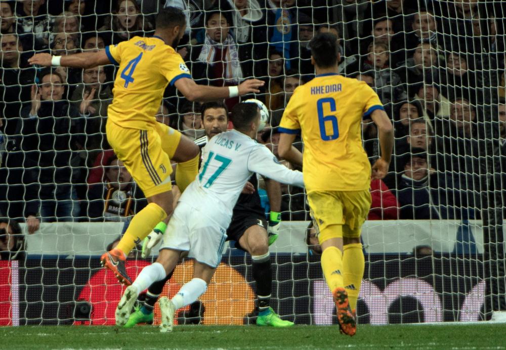 Real Madrid’s midfielder Lucas Vazquez (C) is fouled by Juventus’ defender Medhi Benatia (L) in front of goalkeeper Gianluigi Buffon during their UEFA Champions League quarterfinal second leg match at the Santiago Bernabeu Stadium in Madrid Wednesday. — AFP 