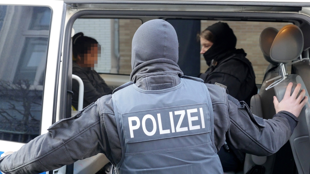Police arrest a suspicious person during a police raid in the early morning in Siegen, Germany, on Wednesday. — EPA